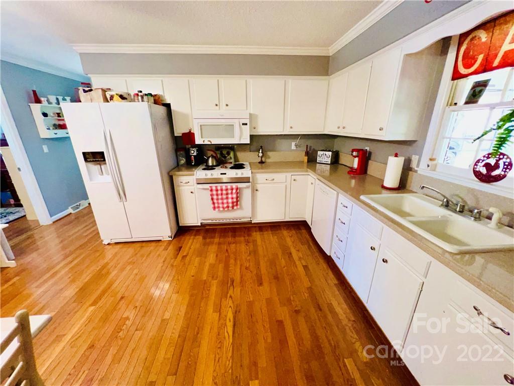 13701 Thompson Road Mint Hill, NC 28105 - Photo 22 of 25 a kitchen with granite countertop white cabinets and white appliances