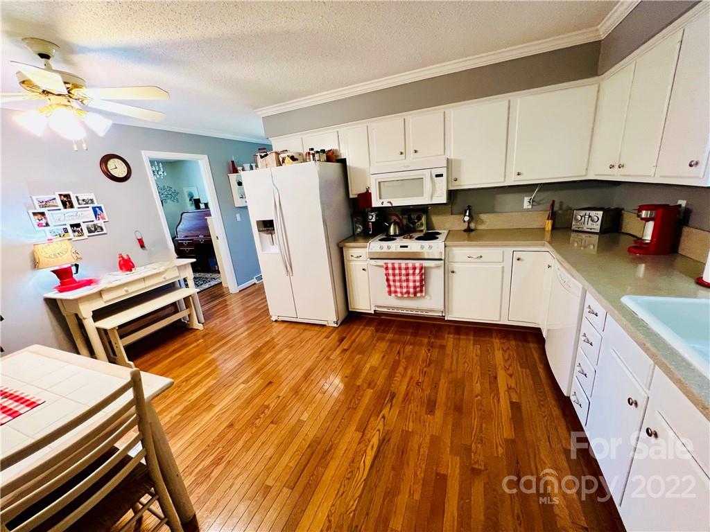 13701 Thompson Road Mint Hill, NC 28105 - Photo 24 of 25 a kitchen with a refrigerator and white cabinets