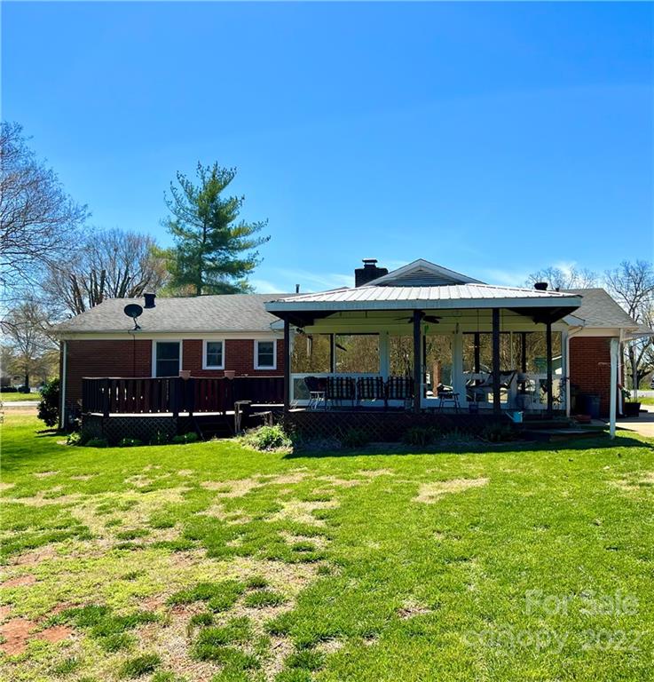 13701 Thompson Road Mint Hill, NC 28105 - Photo 4 of 25 a view of a white house with a big yard and large trees