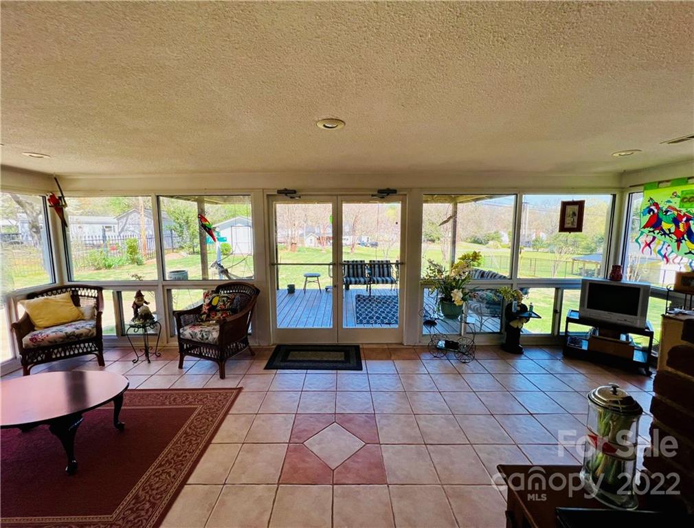 13701 Thompson Road Mint Hill, NC 28105 - Photo 9 of 25 a living room with furniture floor to ceiling fan and a floor to ceiling window