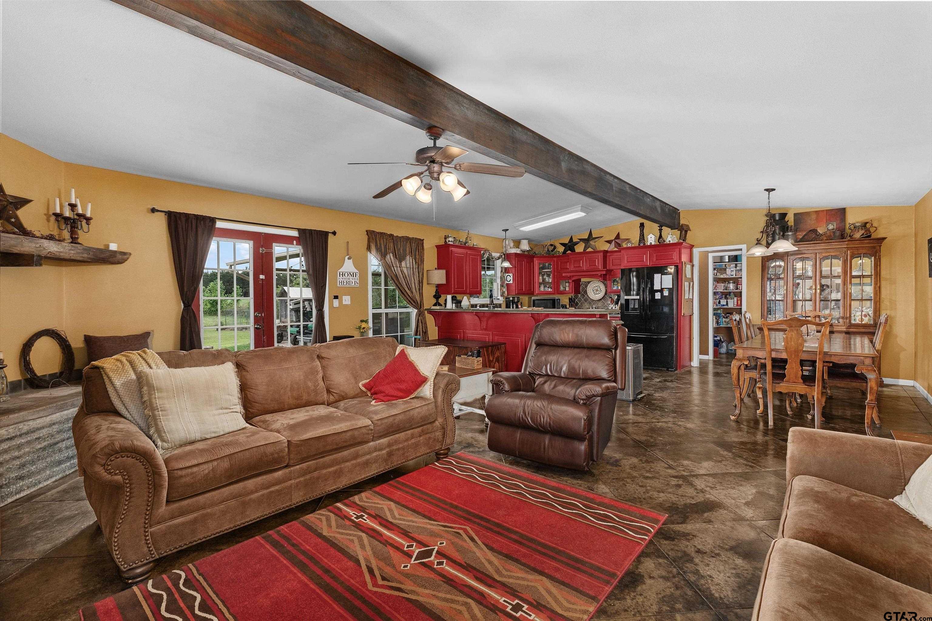 8550 New Hope Road Gilmer, TX 75645 - Photo 5 of 12 a living room with furniture a rug and a chandelier
