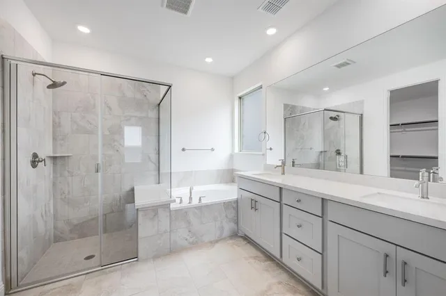a bathroom with a double vanity sink mirror double and shower