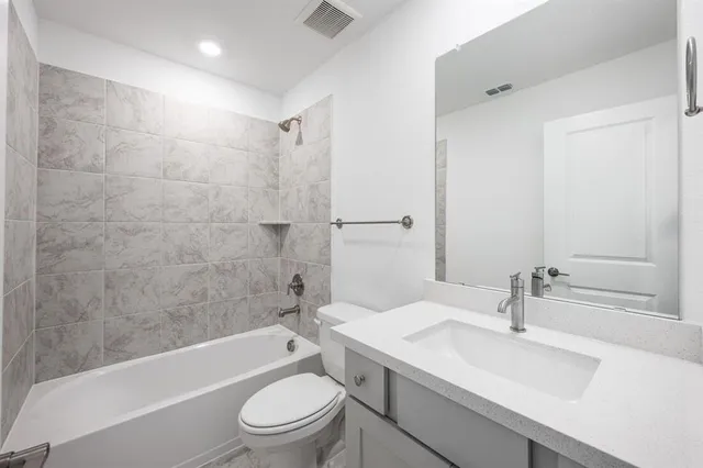 a bathroom with a sink a toilet and a bathtub
