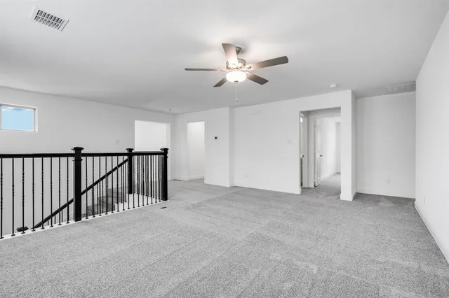 a view of a hallway with a ceiling fan