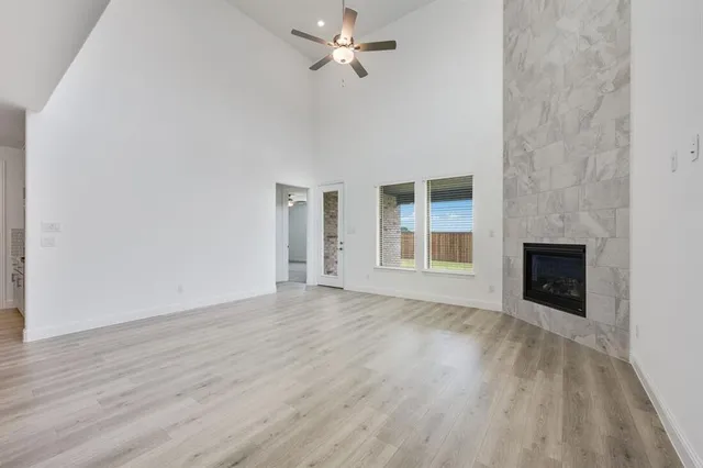 a view of an empty room with a fireplace and a window