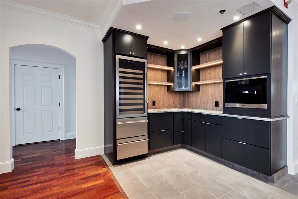 234 Causeway Street, Unit 913/813 Boston, MA 02114 - Photo 15 of 22 a kitchen with a refrigerator and cabinets
