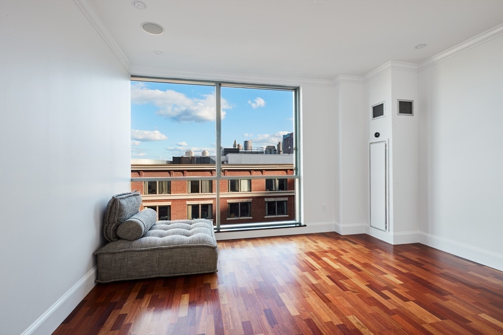 234 Causeway Street, Unit 913/813 Boston, MA 02114 - Photo 21 of 22 a living room with furniture and a large window