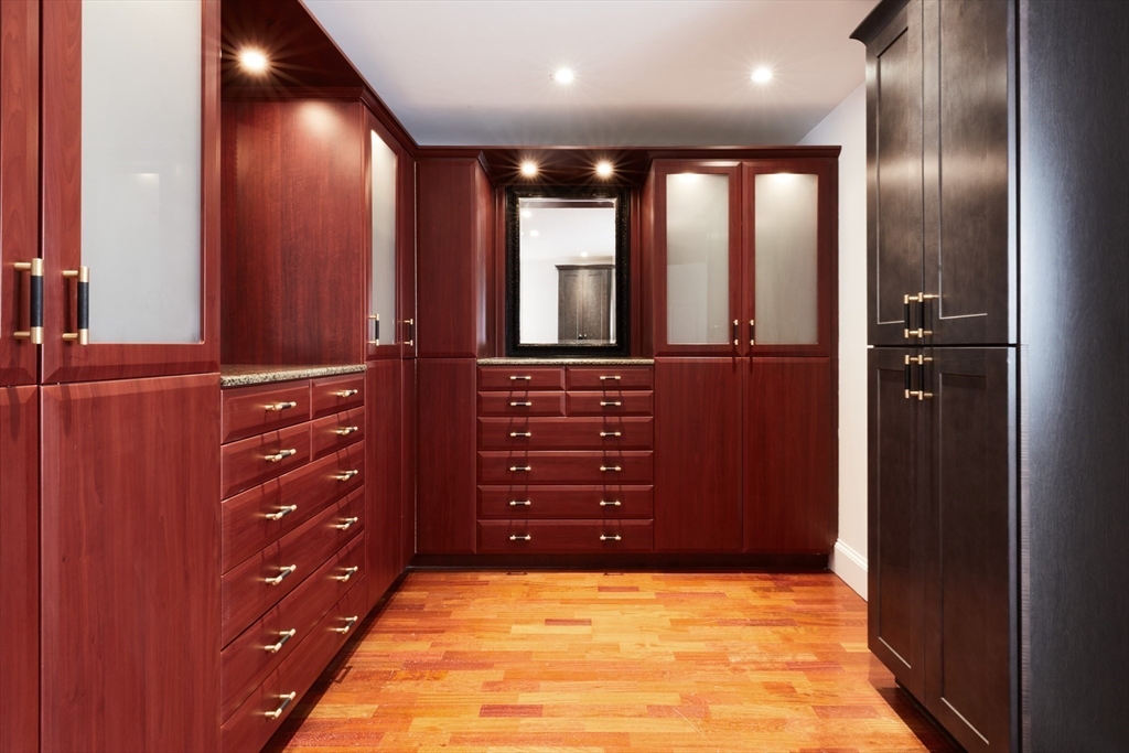 234 Causeway Street, Unit 913/813 Boston, MA 02114 - Photo 6 of 22 wooden floor with cabinet and mirror