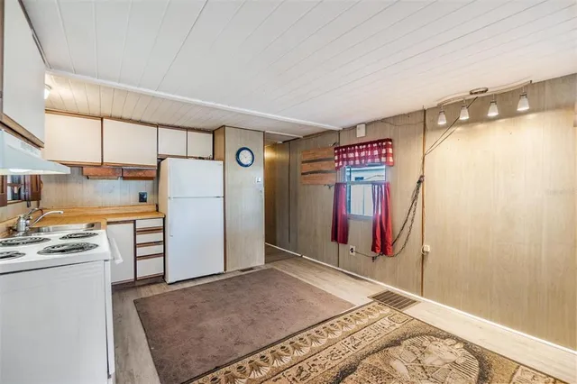 a view of a refrigerator in kitchen and utility room