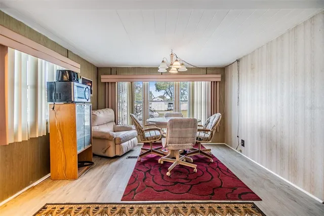 a living room with furniture large window and rug