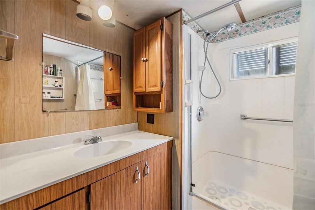 5646 Ave New Port New Port Richey, FL 34652 - Photo 17 of 29 a bathroom with a shower sink and mirror