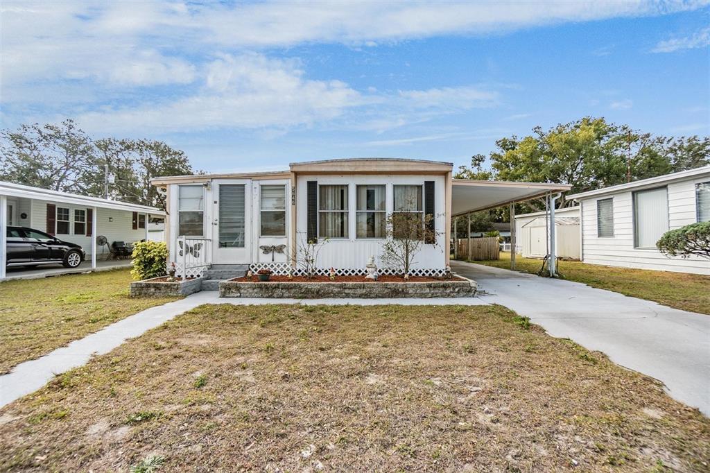 5646 Ave New Port New Port Richey, FL 34652 - Photo 2 of 29 a view of a house with swimming pool and a yard