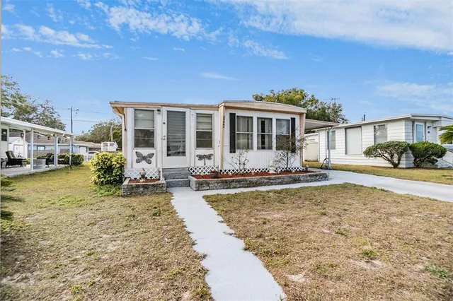 a view of a house with swimming pool and sitting area