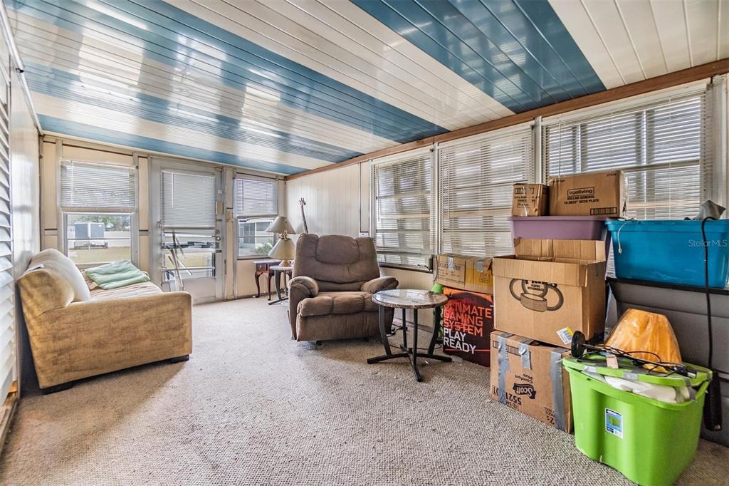 5646 Ave New Port New Port Richey, FL 34652 - Photo 7 of 29 a living room with furniture a flat screen tv and a table