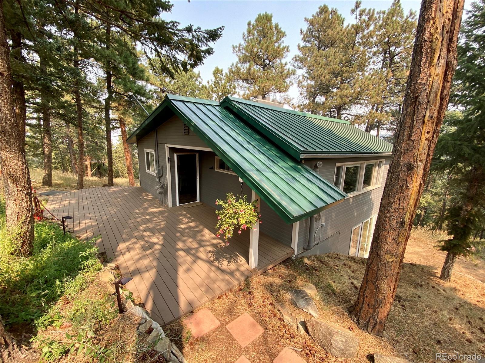 44 Pine Road Golden, CO 80401 - Photo 1 of 35 a house with trees in the background