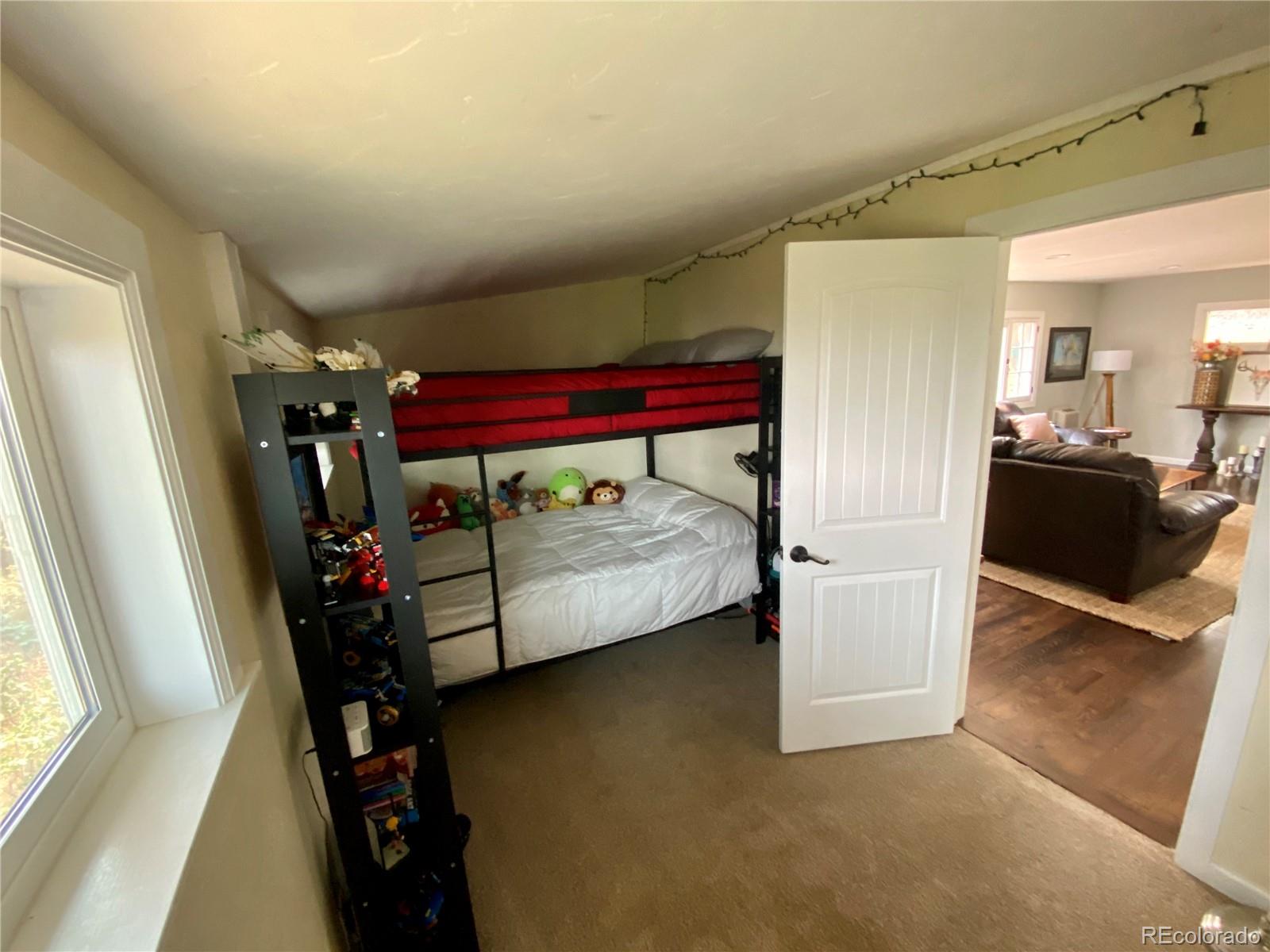 44 Pine Road Golden, CO 80401 - Photo 15 of 35 a bedroom with furniture and a flat tv screen