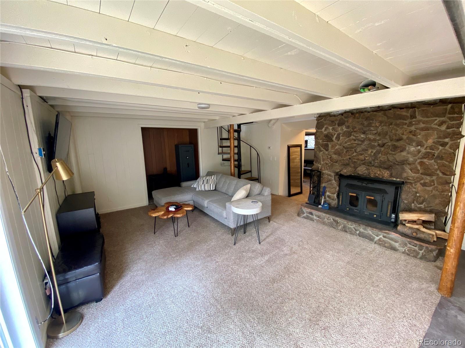 44 Pine Road Golden, CO 80401 - Photo 18 of 35 a living room with furniture and a fireplace