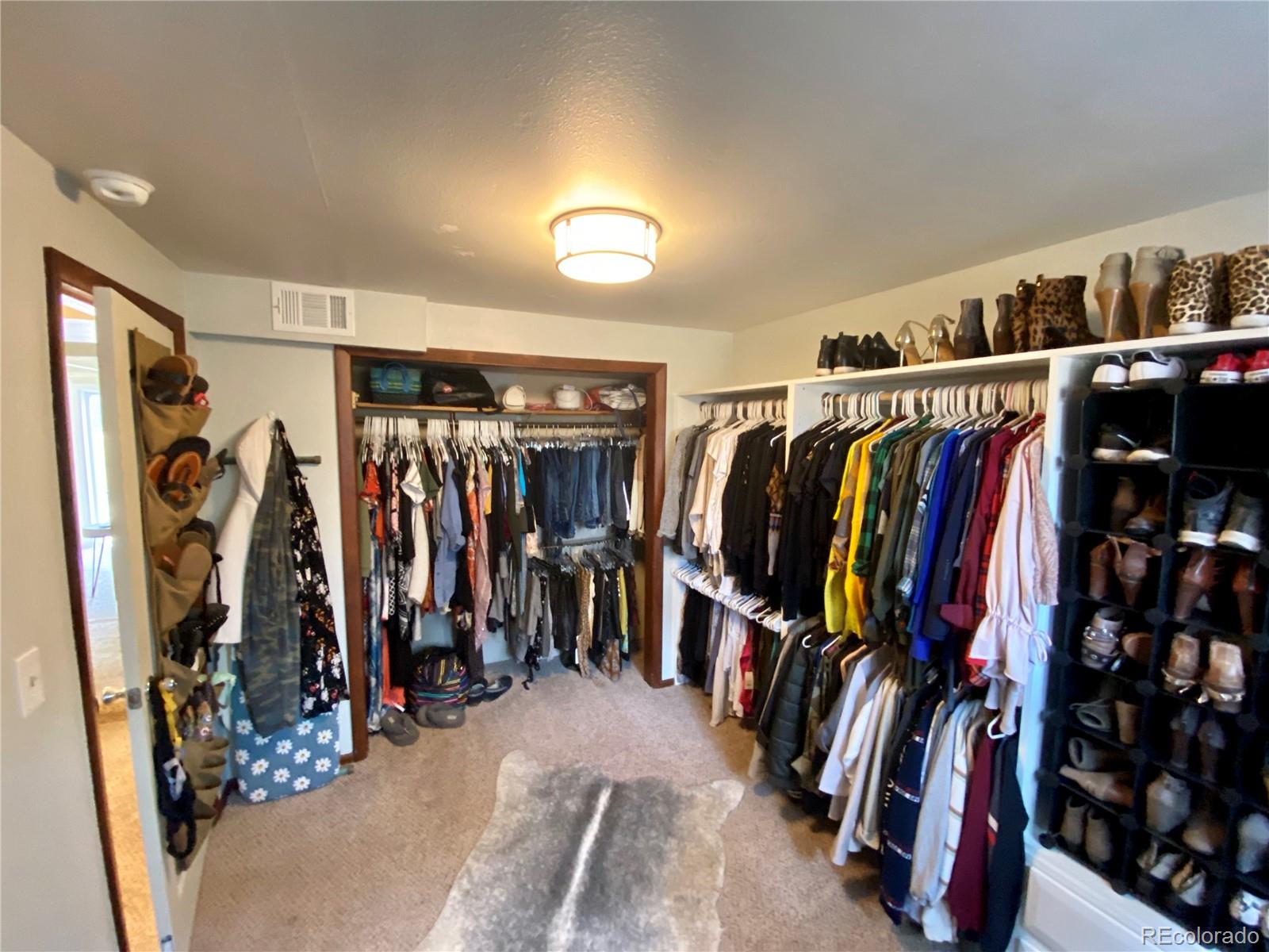 44 Pine Road Golden, CO 80401 - Photo 27 of 35 a view of walk in closet with clothes