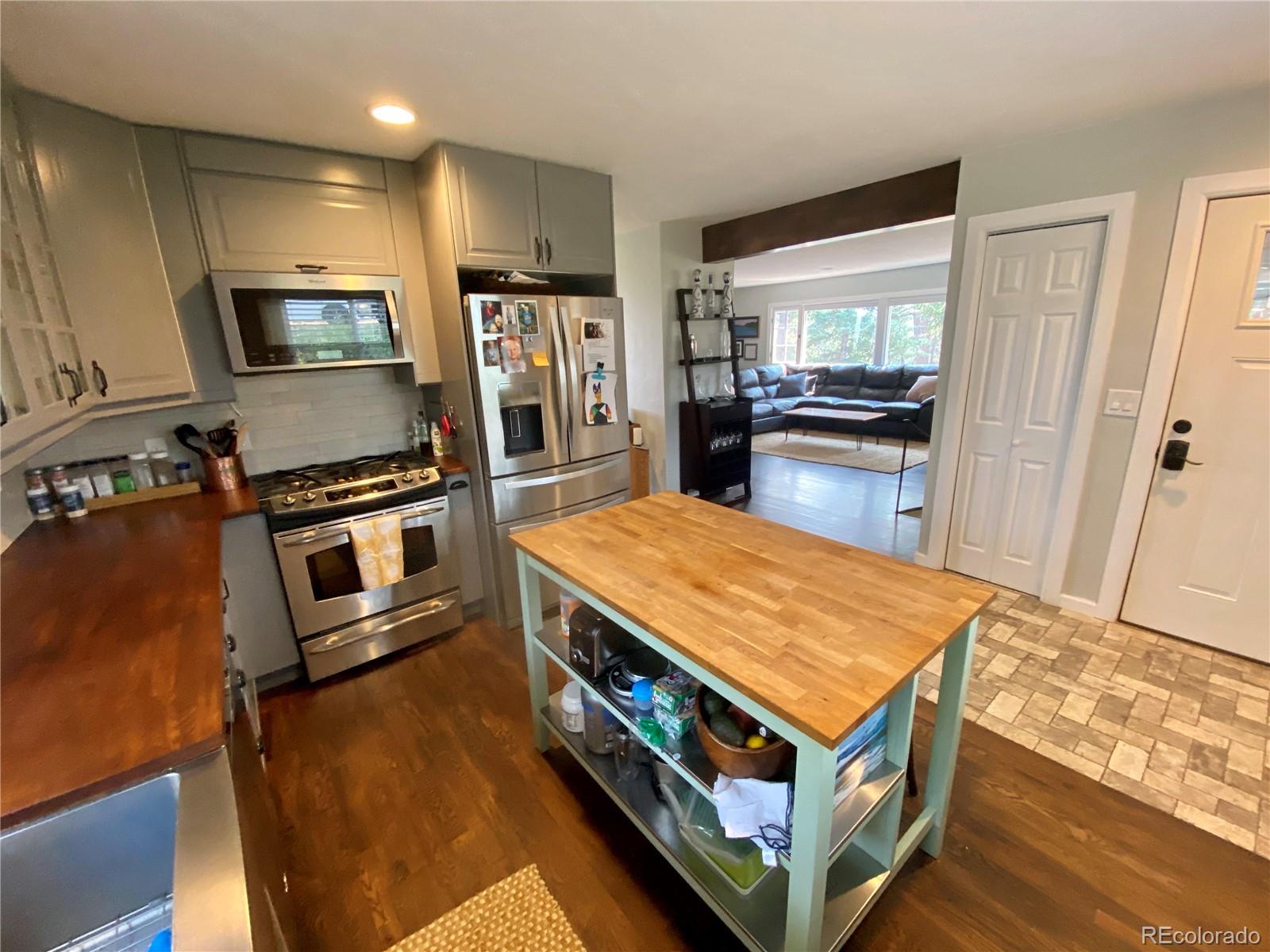 44 Pine Road Golden, CO 80401 - Photo 6 of 35 a kitchen with stainless steel appliances granite countertop a stove and a refrigerator