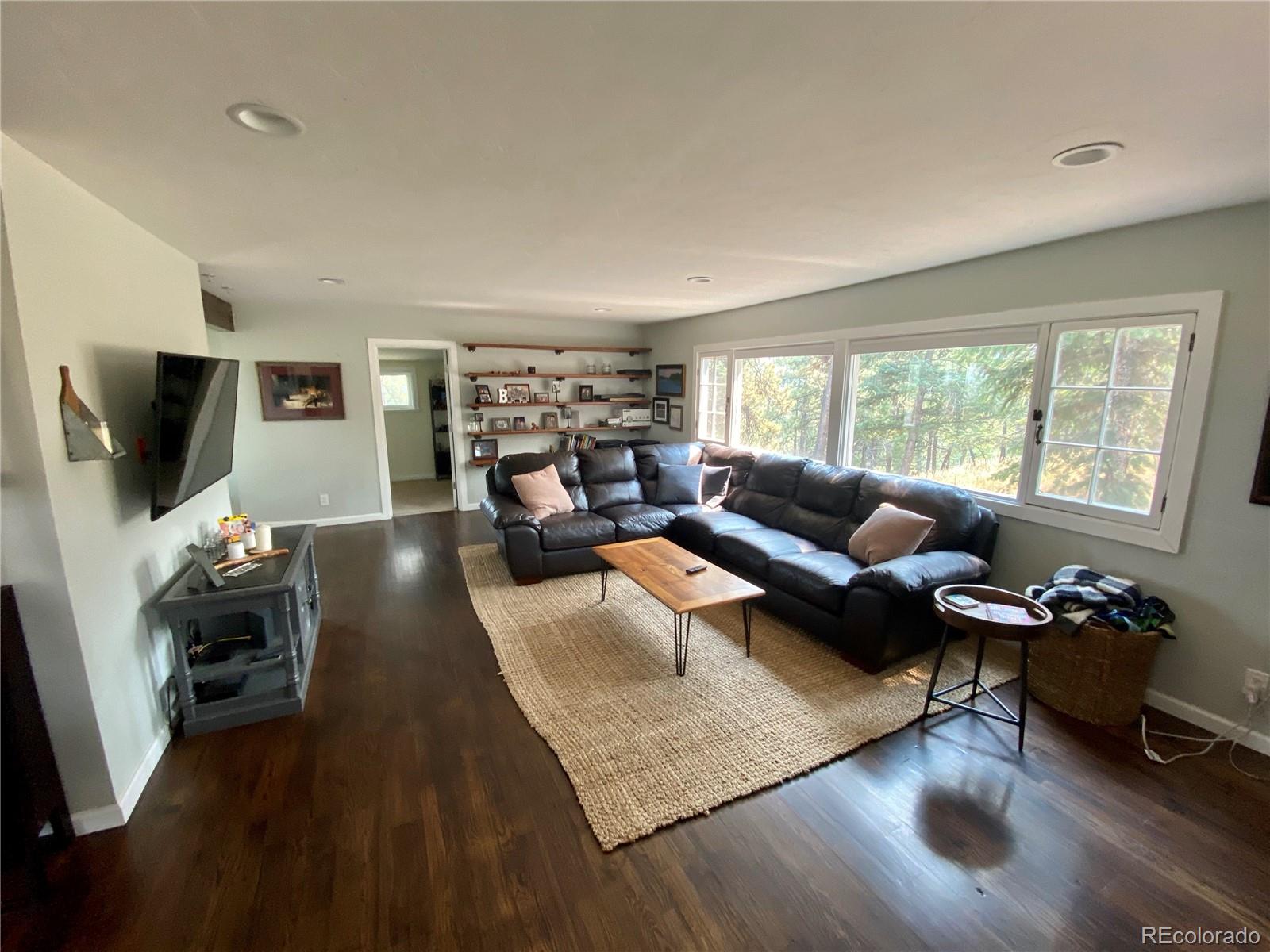 44 Pine Road Golden, CO 80401 - Photo 7 of 35 a living room with furniture and a flat screen tv