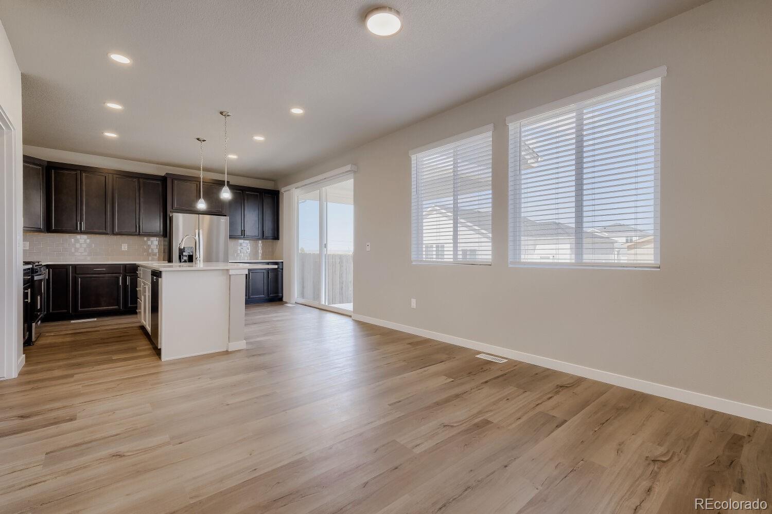 471 Atchison Way Calhan, CO 80808 - Photo 11 of 31 a view of kitchen with wooden floor and window