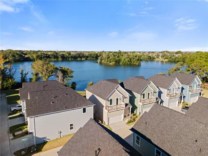 an aerial view of a house with outdoor space and lake view
