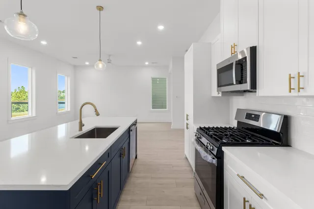 a kitchen that has a sink and a stove