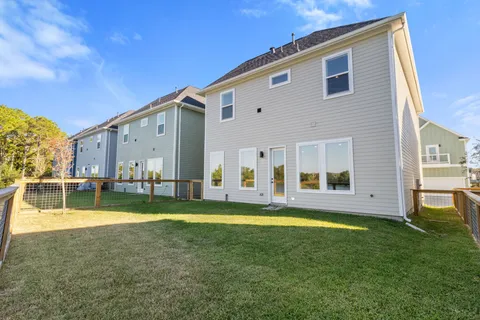a view of a house with a yard and a patio
