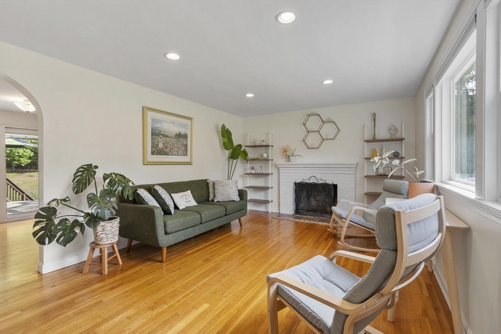6 Edith Road Hudson, MA 01749 - Photo 4 of 30 a living room with furniture a fireplace and a flat screen tv