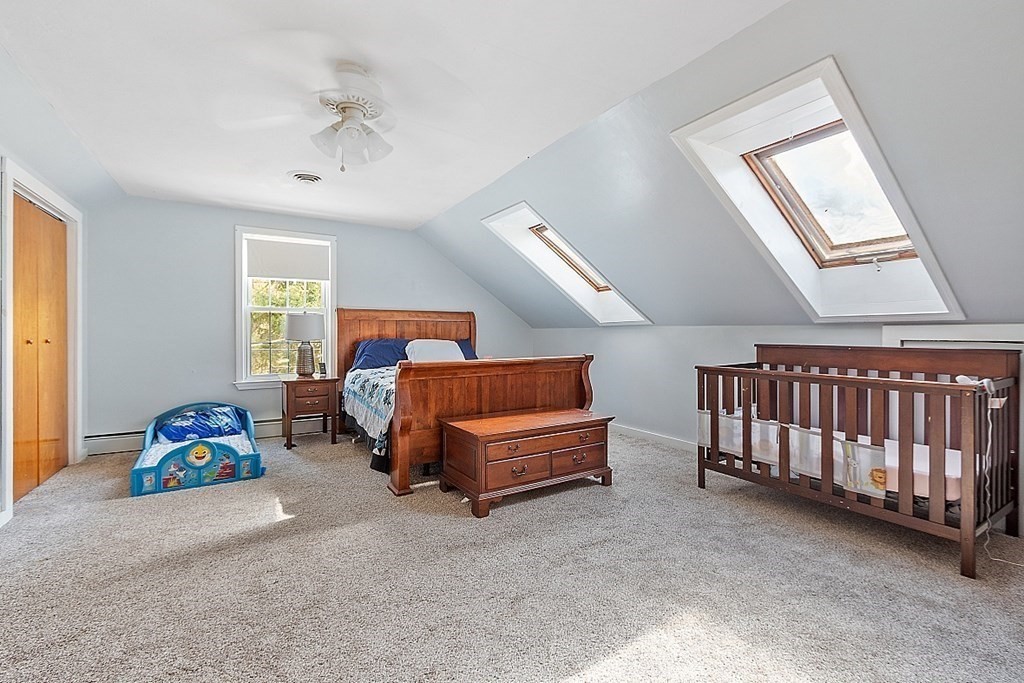 479-483 Gleasondale Road Stow, MA 01775 - Photo 12 of 40 a bedroom with furniture and a large window