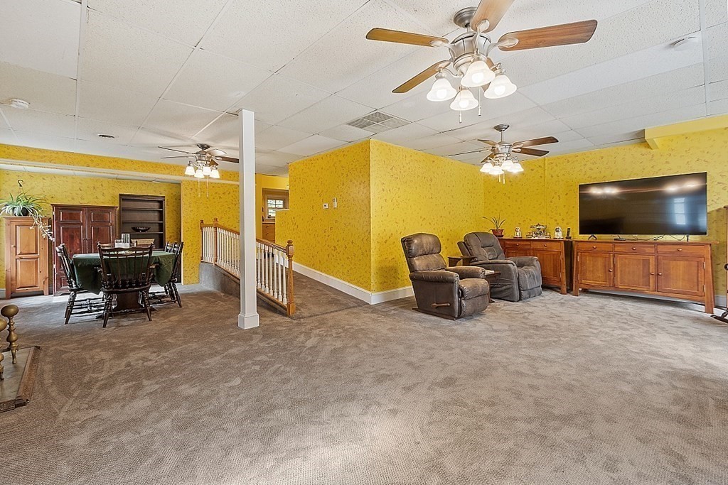 479-483 Gleasondale Road Stow, MA 01775 - Photo 15 of 40 a view of a livingroom with furniture and a flat screen tv