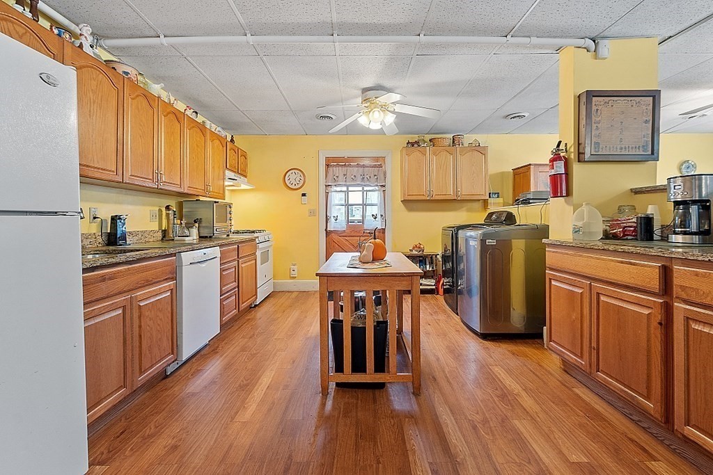 479-483 Gleasondale Road Stow, MA 01775 - Photo 22 of 40 a kitchen with granite countertop a sink appliances cabinets and wooden floor