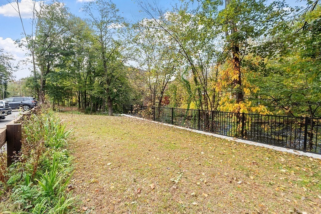 479-483 Gleasondale Road Stow, MA 01775 - Photo 33 of 40 a view of swimming pool with large trees and plants