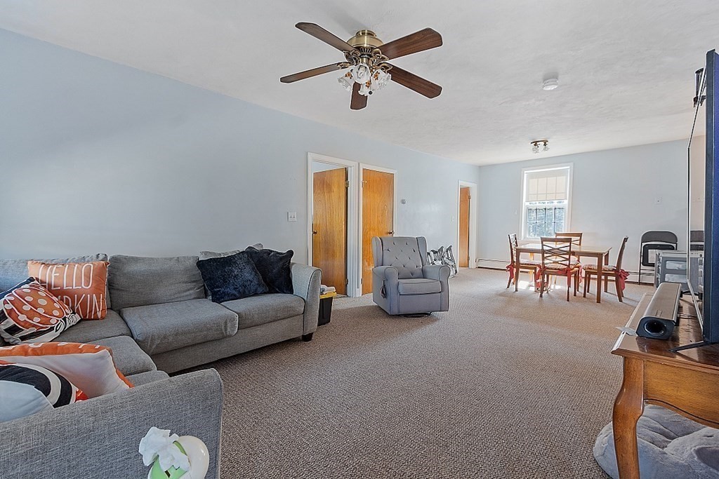 479-483 Gleasondale Road Stow, MA 01775 - Photo 4 of 40 a living room with furniture and a chandelier