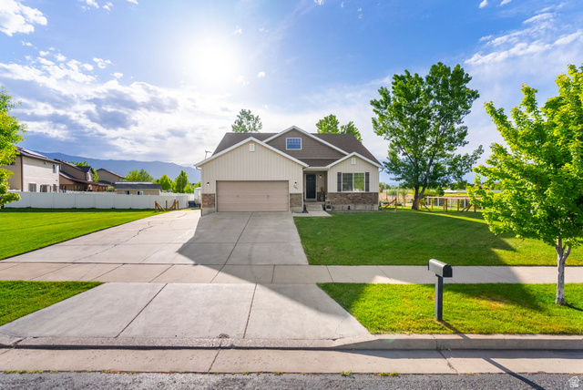 2485 South 1100th Street West Logan, UT 84321 - Photo 2 of 53 Contemporary single-family residence featuring a two-car garage, light-colored siding, and stone accents