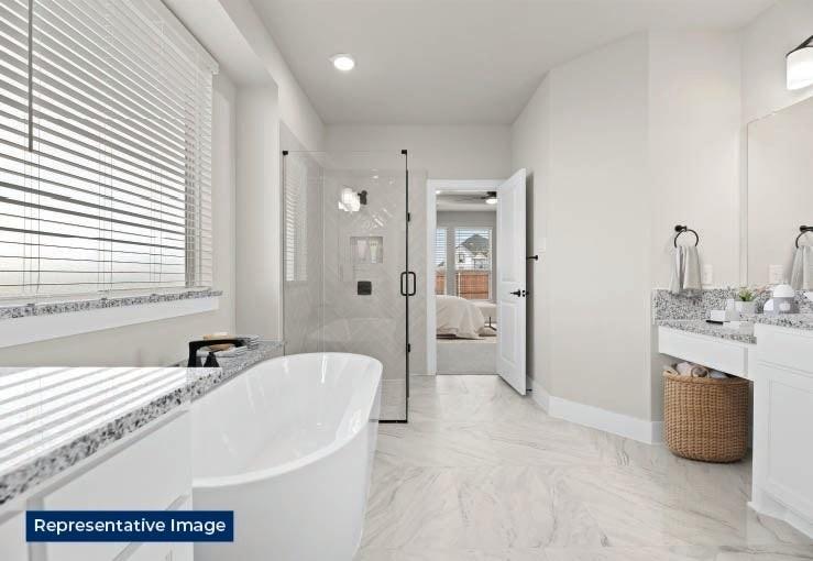 636 Cirrus Lane Fate, TX 75087 - Photo 4 of 7 a bathroom with a tub sink and shower