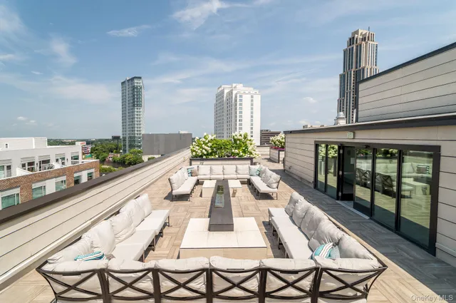 a view of a balcony with chairs and wooden floor