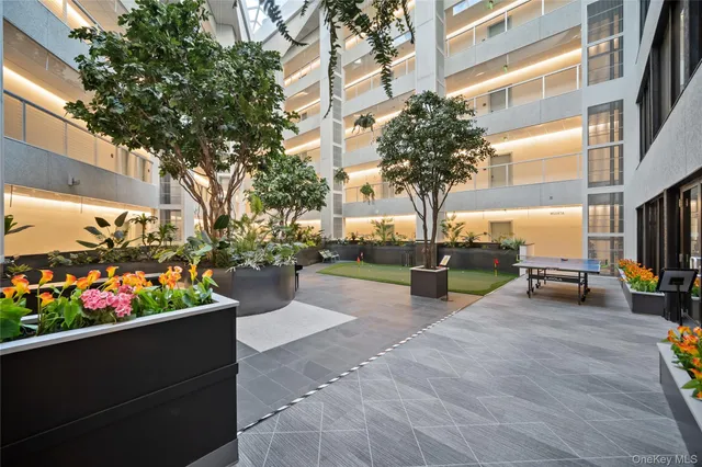 a view of a patio with table and chairs and potted plants