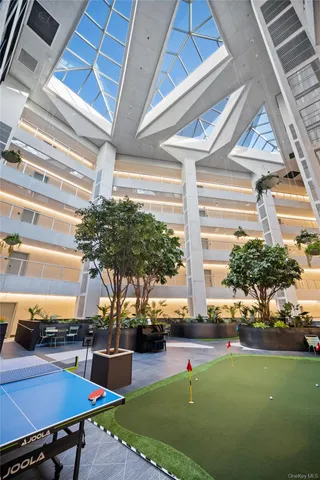 a building outdoor space with patio furniture and potted plants