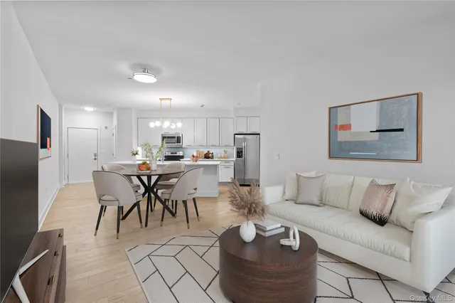 a living room with furniture and kitchen view