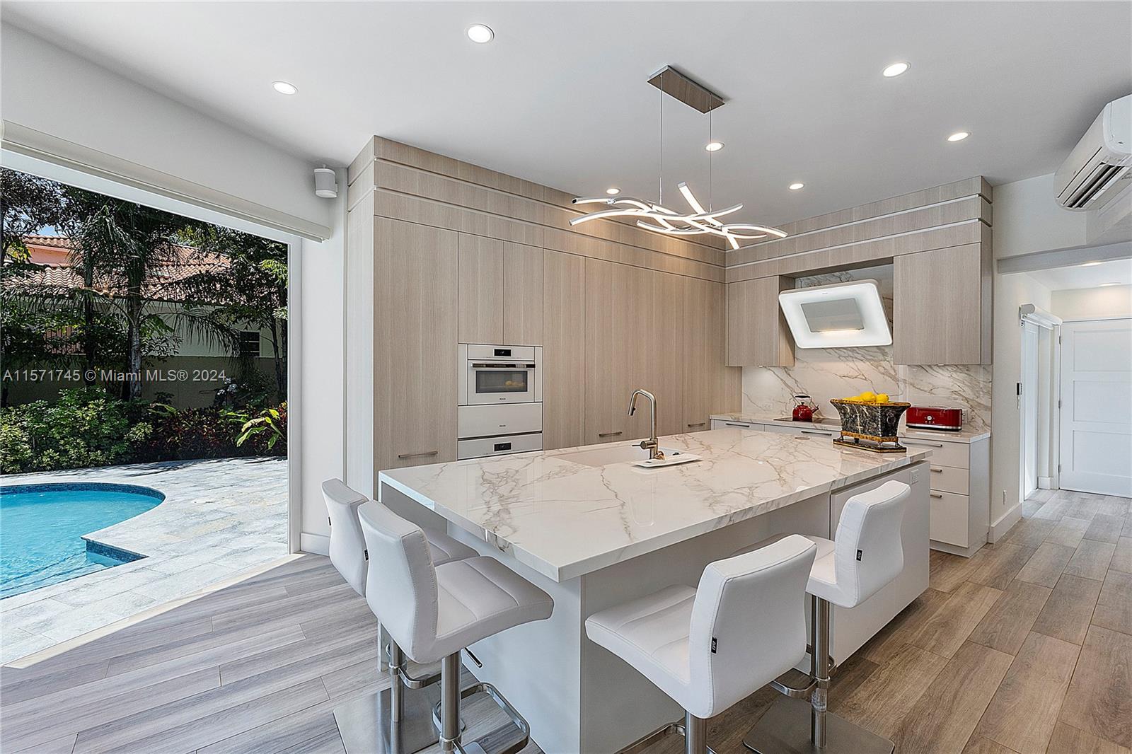1200 Cocoanut Road Boca Raton, FL 33432 - Photo 11 of 25 a large kitchen with kitchen island a large island in it
