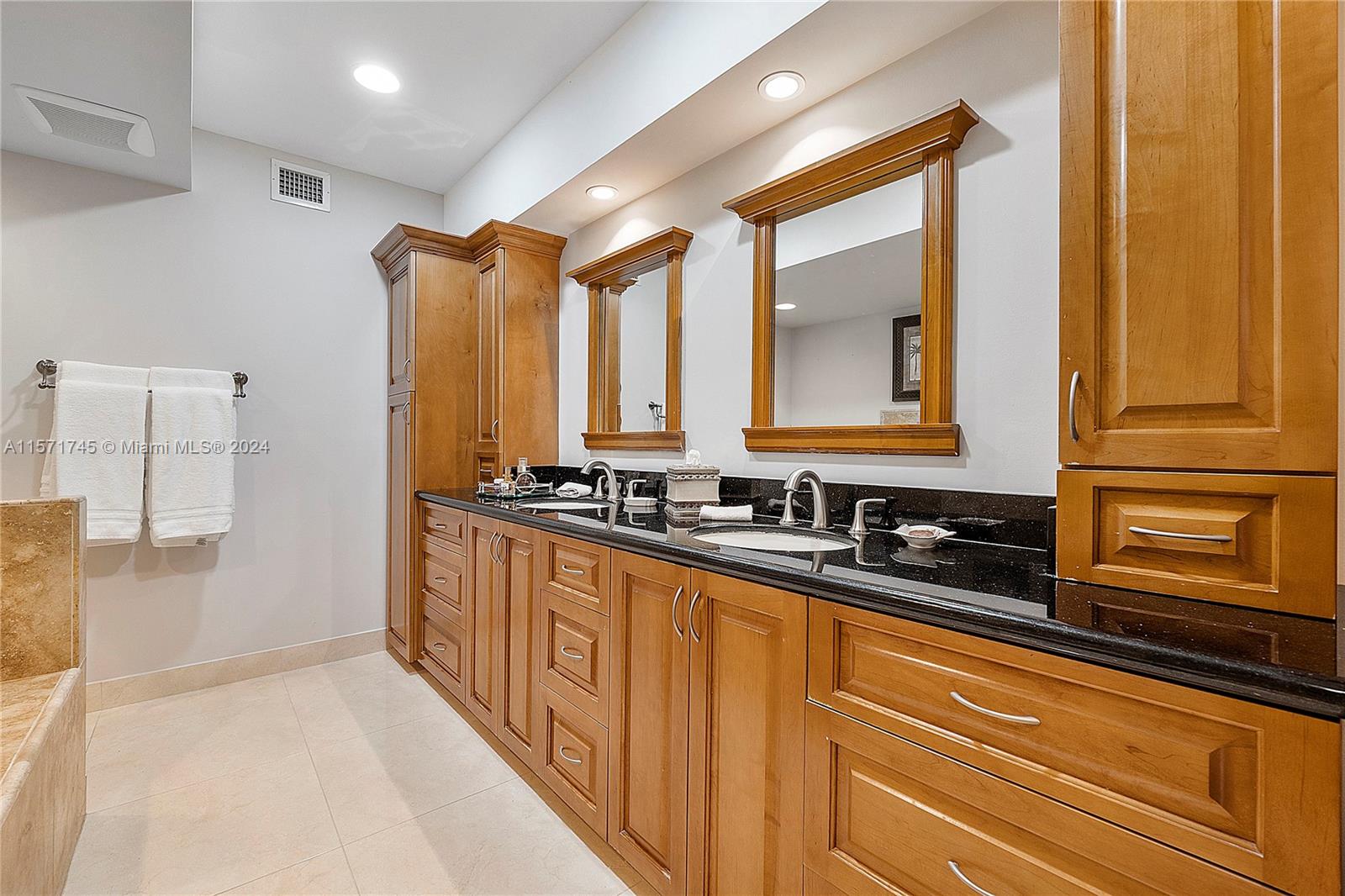 1200 Cocoanut Road Boca Raton, FL 33432 - Photo 12 of 25 a bathroom with a sink a mirror and a bathtub