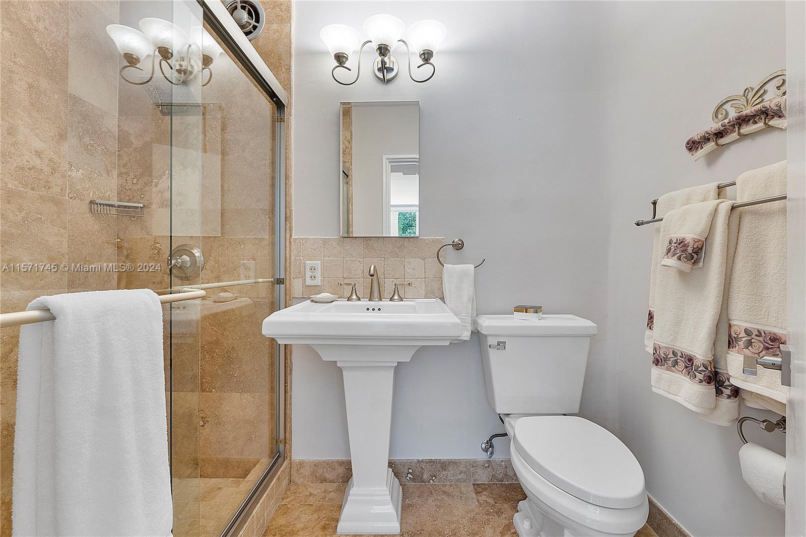 1200 Cocoanut Road Boca Raton, FL 33432 - Photo 15 of 25 a bathroom with a sink mirror vanity and toilet