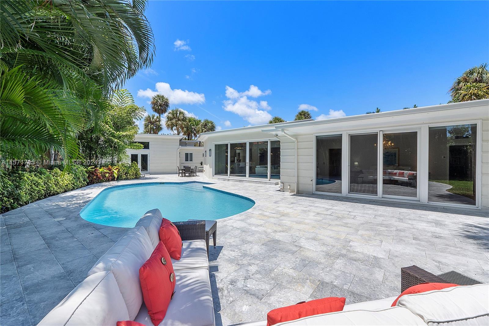 1200 Cocoanut Road Boca Raton, FL 33432 - Photo 17 of 25 a view of a house with swimming pool and porch