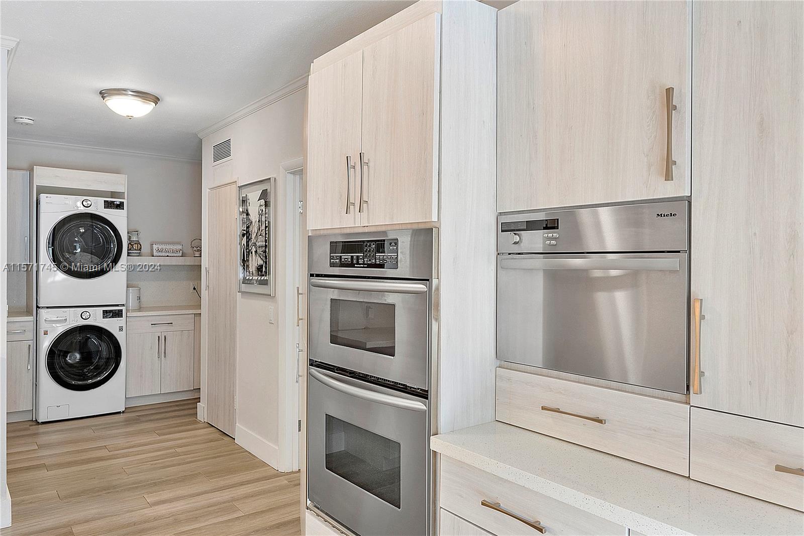 1200 Cocoanut Road Boca Raton, FL 33432 - Photo 20 of 25 a kitchen with stainless steel appliances granite countertop a refrigerator and a stove top oven