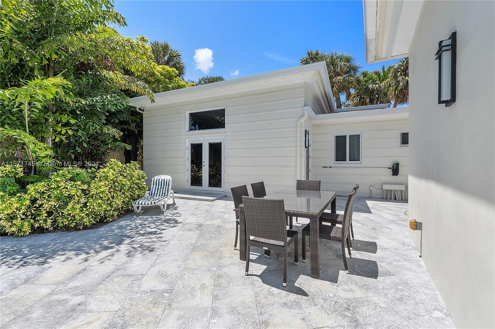 1200 Cocoanut Road Boca Raton, FL 33432 - Photo 22 of 25 a view of a patio with table and chairs and potted plants