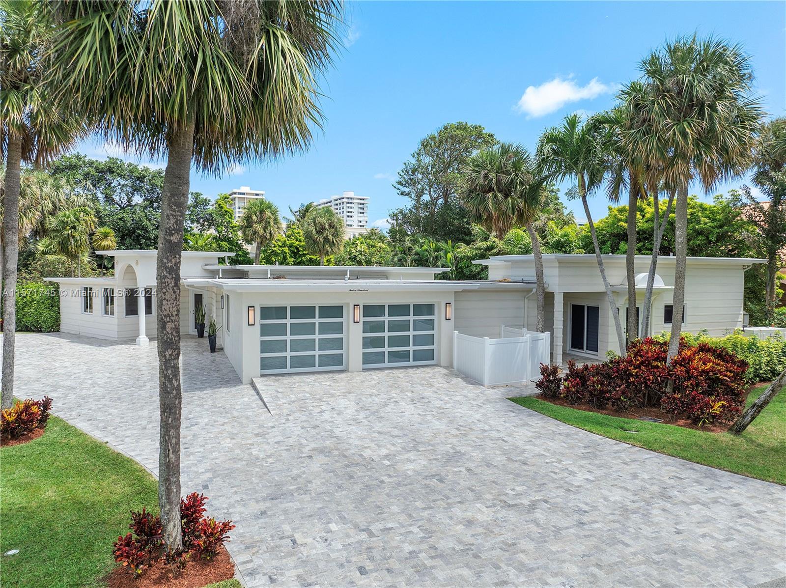 1200 Cocoanut Road Boca Raton, FL 33432 - Photo 5 of 25 front view of a house with a yard and potted plants