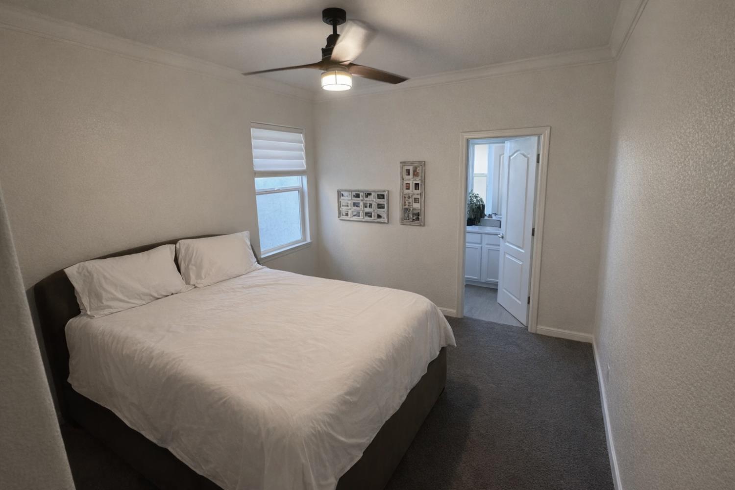 2557 Creek Hollow Road Rocklin, CA 95765 - Photo 19 of 27 a bedroom with a bed and a chandelier