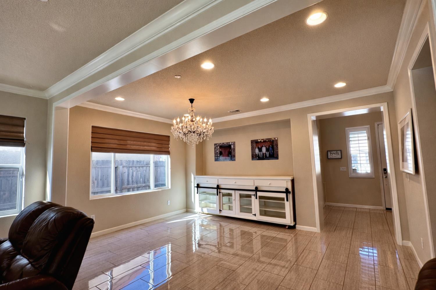 2557 Creek Hollow Road Rocklin, CA 95765 - Photo 6 of 27 a living room with furniture and a chandelier