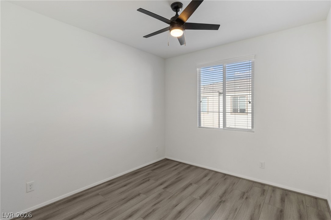 6227 Runestone Street Las Vegas, NV 89113 - Photo 8 of 33 This bright room features a contemporary ceiling fan and durable flooring, creating a comfortable living space.